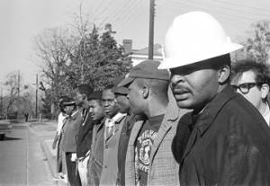 Wendell Paris and other students from Tuskegee Institute lined up along a street during a demonstration to protest the murder of Samuel L. Younge, a civil rights worker.