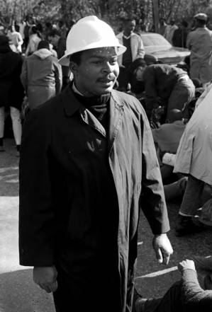 Wendell Paris walking through a crowd during a student demonstration in Tuskegee, Alabama, to protest the murder of Samuel L. Younge, a civil rights worker.