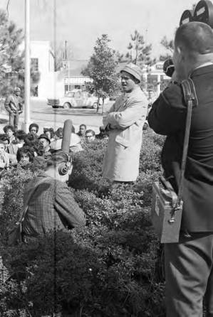 Dr. Frank Toland addressing a crowd seated in front of the Confederate monument in Tuskegee, Alabama, during a student demonstration to protest the murder of Samuel L. Younge, a civil rights worker.