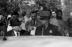 Police officer speaking to an officer from the Macon County Sheriff's Department during a student demonstration in Tuskegee, Alabama, to protest the murder of Samuel L. Younge, a civil rights worker.