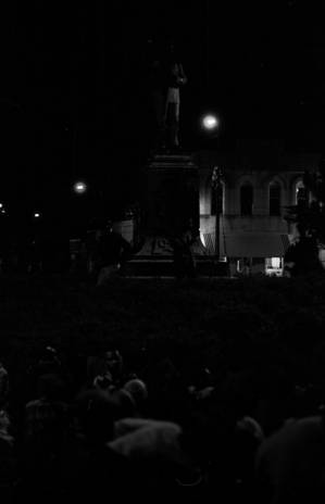 Crowd seated in front of the Confederate monument in Tuskegee, Alabama, during a student demonstration to protest the murder of Samuel L. Younge, a civil rights worker.