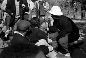 Wendell Paris speaking to people seated on a road in Tuskegee, Alabama, during a student demonstration to protest the murder of Samuel L. Younge, a civil rights worker.