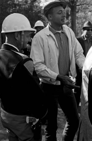 Young man speaking to a policeman during a student demonstration in Tuskegee, Alabama, to protest the murder of Samuel L. Younge, a civil rights worker.