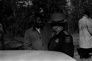 Herman Richardson speaking to an officer from the Macon County Sheriff's Department during a student demonstration in Tuskegee, Alabama, to protest the murder of Samuel L. Younge, a civil rights worker.