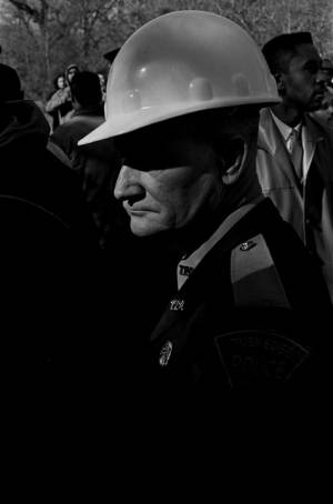 Policemen standing in a crowd during a student demonstration in Tuskegee, Alabama, to protest the murder of Samuel L. Younge, a civil rights worker.