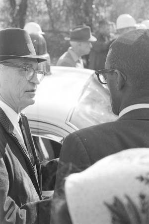 Police officer speaking speaking to Dr. Burcham Phillips during a student demonstration in Tuskegee, Alabama, to protest the murder of Samuel L. Younge, a civil rights worker.