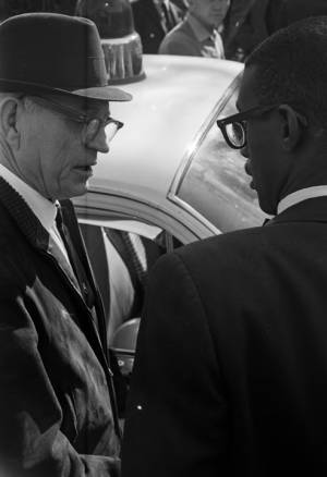Police officer speaking speaking to Dr. Burcham Phillips during a student demonstration in Tuskegee, Alabama, to protest the murder of Samuel L. Younge, a civil rights worker.
