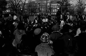 Wendell Paris addressing students gathered outside the Collis P. Huntington Memorial Building at Tuskegee Institute, during a demonstration protesting the murder of Samuel L. Younge.