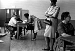 Woman registering to vote with federal examiners in at the Fort Charles Henderson armory in Troy, Alabama.
