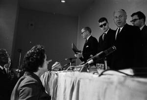 Woman speaking to Senator Jacob Javits before or after a hearing held by the Senate Subcommittee on Employment, Manpower, and Poverty at the Heidelberg Hotel in Jackson, Mississippi.