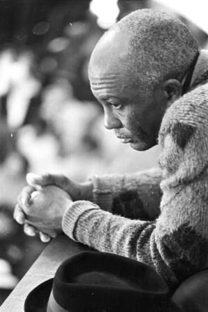 Man sitting in an audience at Tabernacle Baptist Church in Selma, Alabama, probably listening to Martin Luther King, Jr., speak.