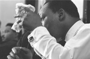 Martin Luther King, Jr., seated during a meeting at Maggie Street Baptist Church in Montgomery, Alabama.