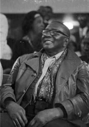 Man sitting in an audience at St. Paul AME Church in Birmingham, Alabama, probably listening to Martin Luther King, Jr., speak.