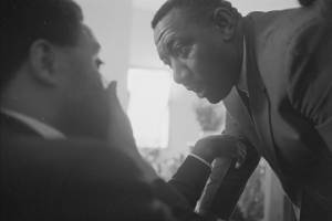 Albert Turner speaking to Ralph Abernathy at a large gathering, probably at First Baptist Church in Eutaw, Alabama.