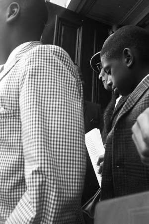 Martin Luther King, Jr., speaking to people as they leave Dexter Avenue Baptist Church in Montgomery, Alabama.