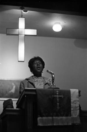 Woman singing before an audience at Hall Street Baptist Church in Montgomery, Alabama.