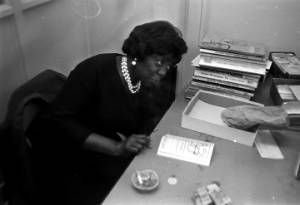 Idessa Williams of the Montgomery Improvement Association, seated at a table during an interview.