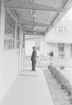 Man standing outside a polling station.