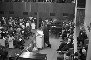 Martin Luther King, Jr., speaking to an audience in a large, modern church building, probably in Birmingham, Alabama.