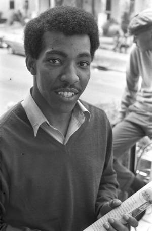 Stoney Crooks of SCLC, standing on a porch or balcony above a street.
