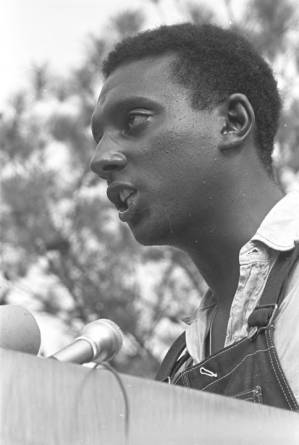 Stokely Carmichael addressing a crowd in front of the state capitol in Jackson, Mississippi, at the end of the "March Against Fear" begun by James Meredith.