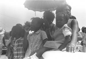 Women and little girls standing outside, observing the "March Against Fear" through Mississippi, begun by James Meredith.
