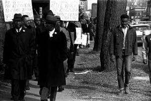 Group marching down a sidewalk in downtown Birmingham, Alabama, during a voter registration drive.