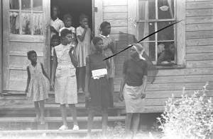 Group of people on the steps of a clapboard house, observing the "March Against Fear" through Mississippi, begun by James Meredith.