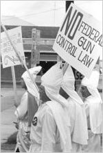 Klansmen carrying signs in a parade during a Ku Klux Klan rally in Montgomery, Alabama.