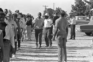 Participants in the "March Against Fear" through Mississippi, walking down a dirt road.