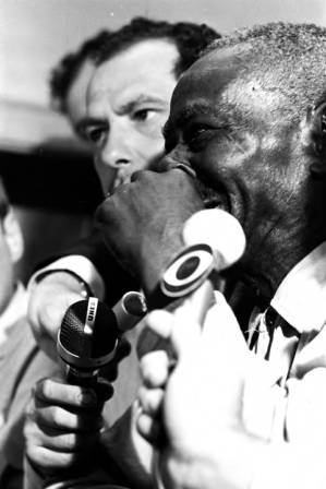 Man sitting at table in an office, registering to vote during the "March Against Fear" through Mississippi, begun by James Meredith.