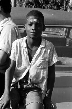 Young boy seated on the trunk of a car during the "March Against Fear" through Mississippi, begun by James Meredith.