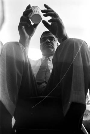 Whitney M. Young, Jr., seated on a platform in front of the state capitol in Jackson, Mississippi, at the end of the "March Against Fear" begun by James Meredith.