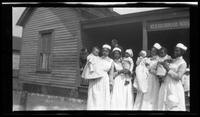 Nurses and Babies in Front of a Neighborhood House, circa 1920