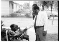 John R. Lewis Talks to an Old Woman During a Voting Rights Tour, circa 1972