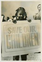 A Young Girl Holding a "Save Our Children" Sign Amongst Demonstrators, 1980
