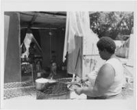 A Woman Cooking on a Metal Garbage Can in Resurrection City, 1968