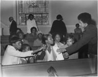 An Unidentified Woman Handing a Cloth to a Woman at the National Women's Candlelight Prayer Service, April 5, 1981