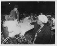 Evelyn G. Lowery Speaking With a Senior Citizen in a Wheelchair, circa 1981