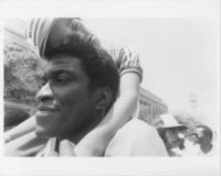 A Sleeping Child Being Carried on a Man's Shoulders During the Pilgrimage to Washington, 1982