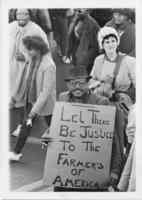 A Demonstrator Smiling with a Protest Sign, circa 1983