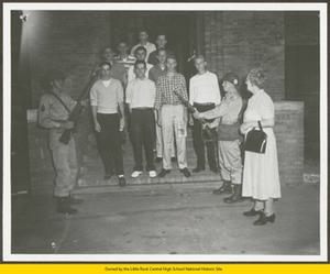 Grace Lorch, ten male students, and two National Guardsmen standing on doorway steps