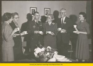 Captain Madden, Elizabeth Huckaby, three unknown women, and one unknown man at faculty tea