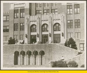 Students sitting and standing by the Central High's front doors