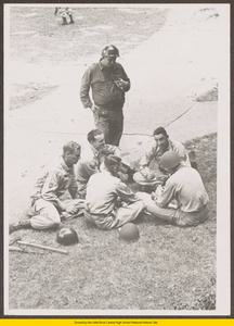 National Guard troops playing cards on lawn in front of Central High School