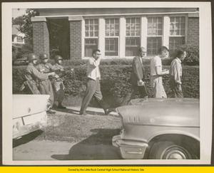 101st Airborne soldiers escort white males from Central High School at bayonet point