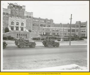 Military troops in Jeeps in front of Central High School