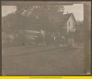 Soldiers standing by parked vehicles