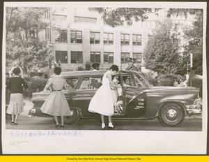 Black students exiting Army station wagon