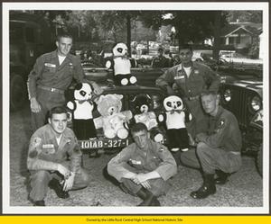 Sergeant Neubauer, Sergeant Hamby, Private Parkes, Private McArthur, and Sergeant Montez with the 101st Airborne soldiers holding teddy bears
